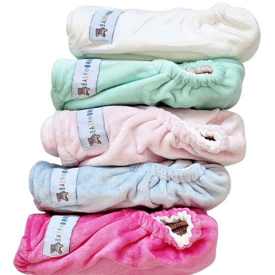 Stack of velour cloth nappies in different pastel colours