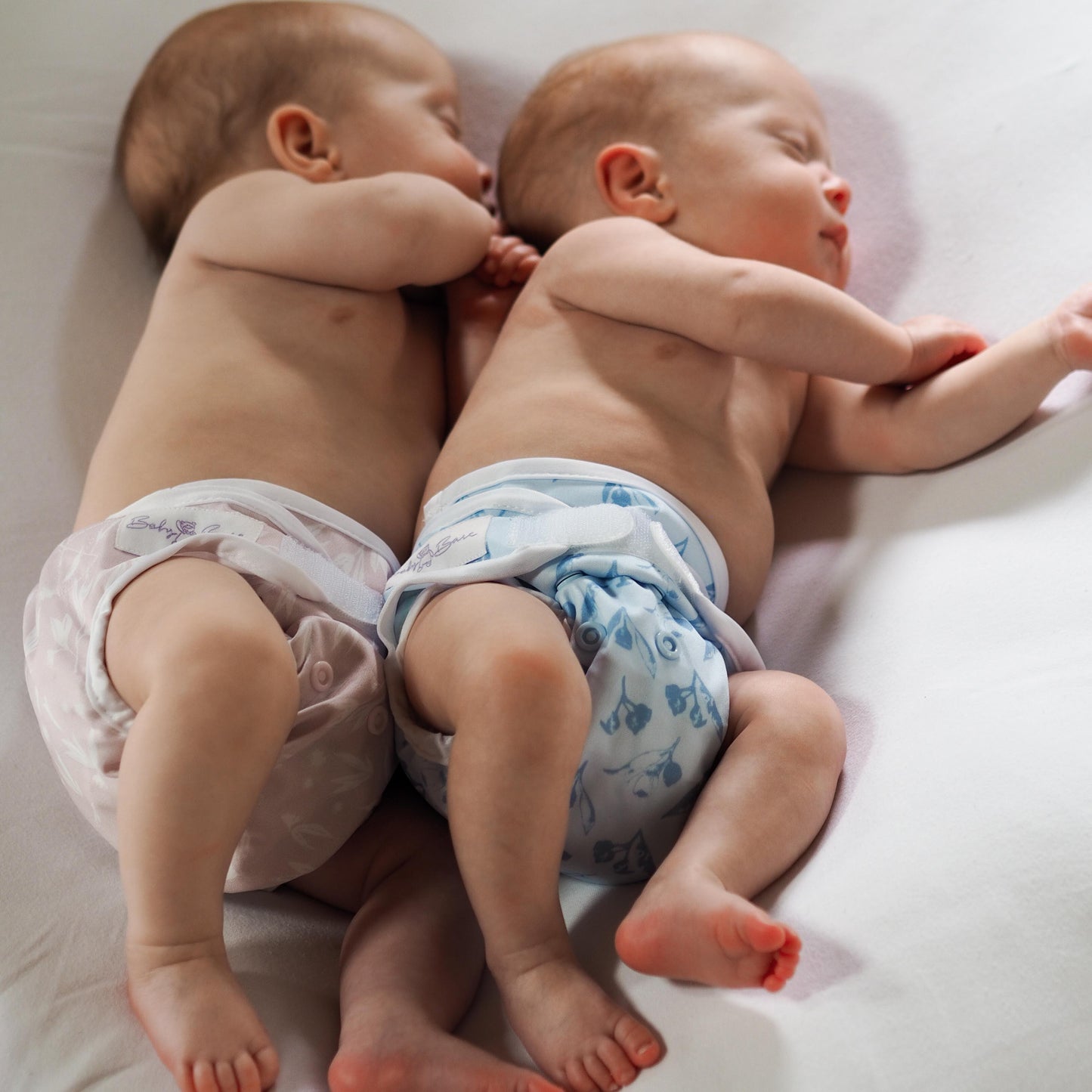 Twins wearing matching cloth nappies
