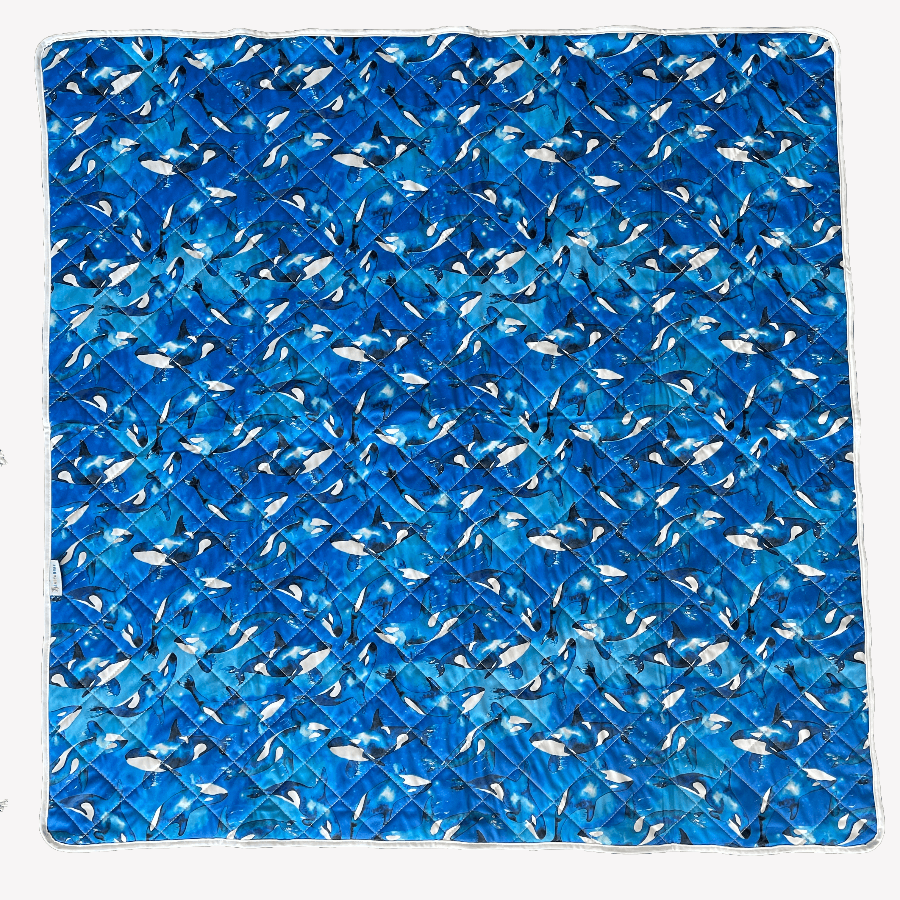 Play mat with orcas print fabric.