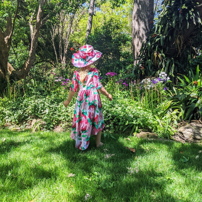 Girl standing among flowers.