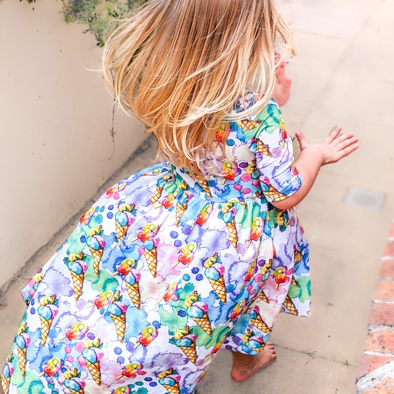 Girl wearing dress with ice cream print.