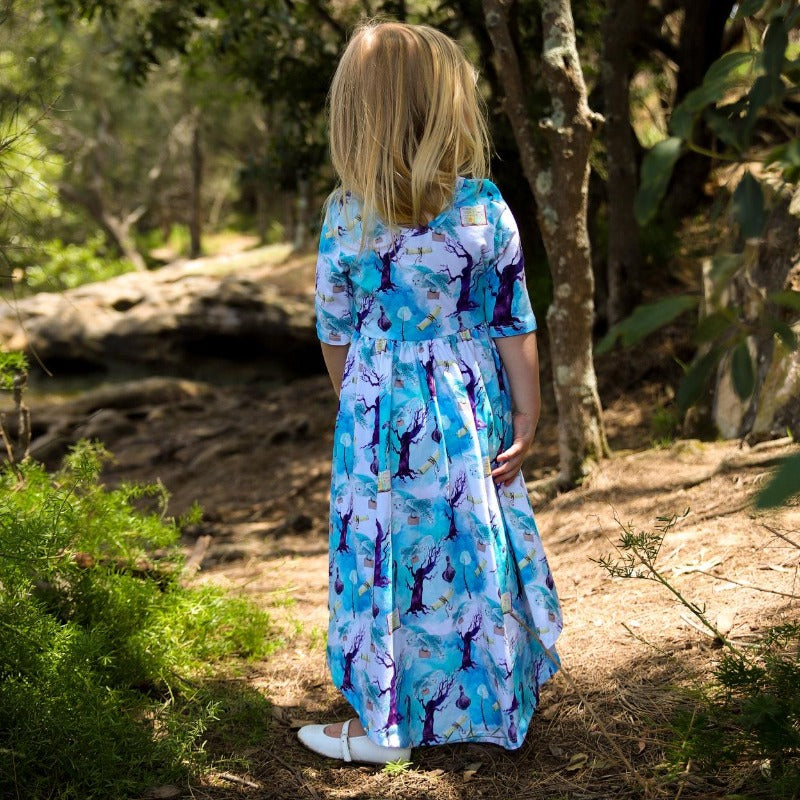 Little girls wearing a blue dress.