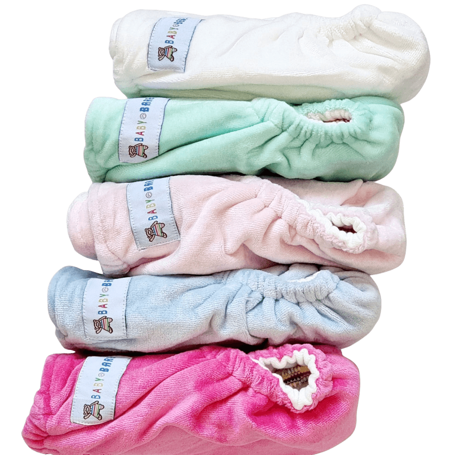 Stack of velour cloth nappies in different pastel colours