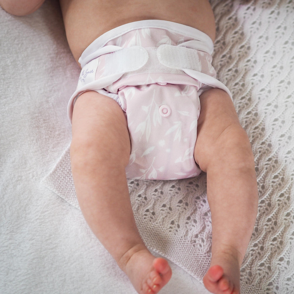 
                  
                    Floral newborn nappy on baby
                  
                