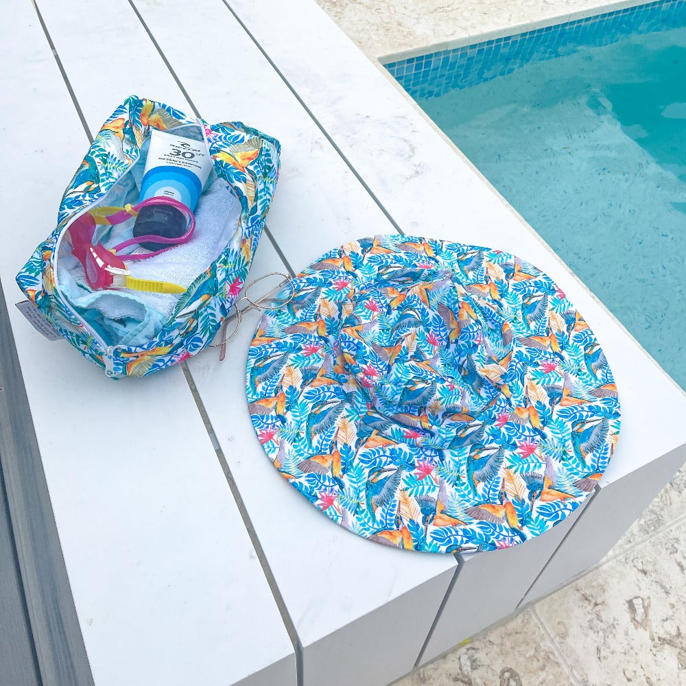 
                  
                    Hat and swim bag sitting next to pool on a table
                  
                