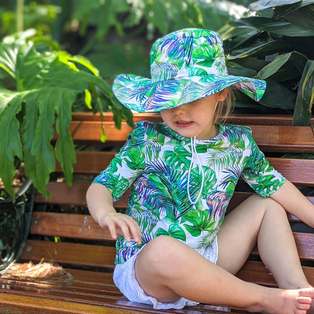 Little girl wearing a macthing hat and t-shirt