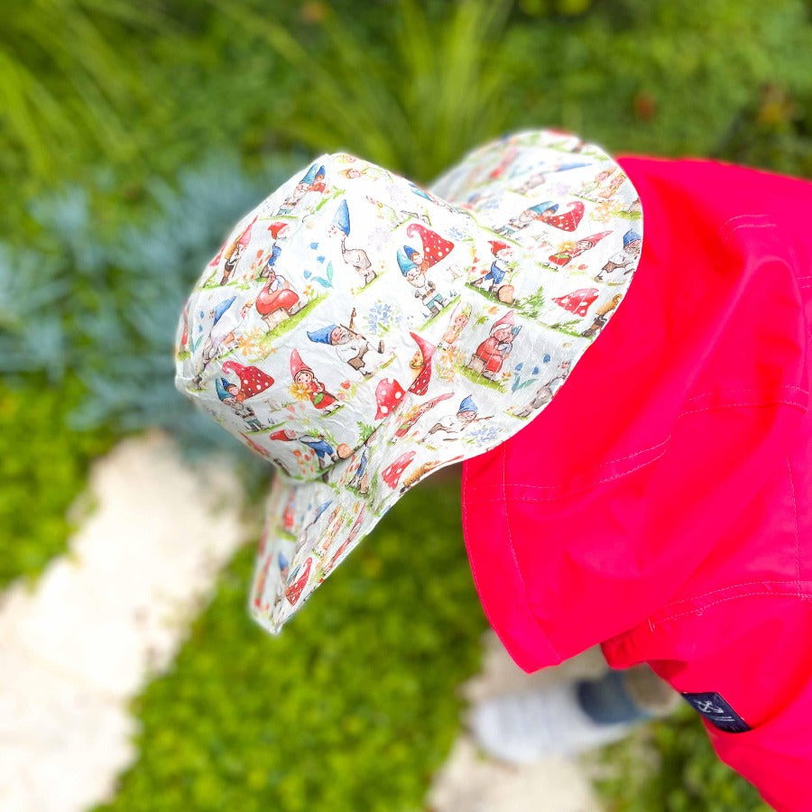 
                  
                    Young child wearing gnome printed hat. 
                  
                