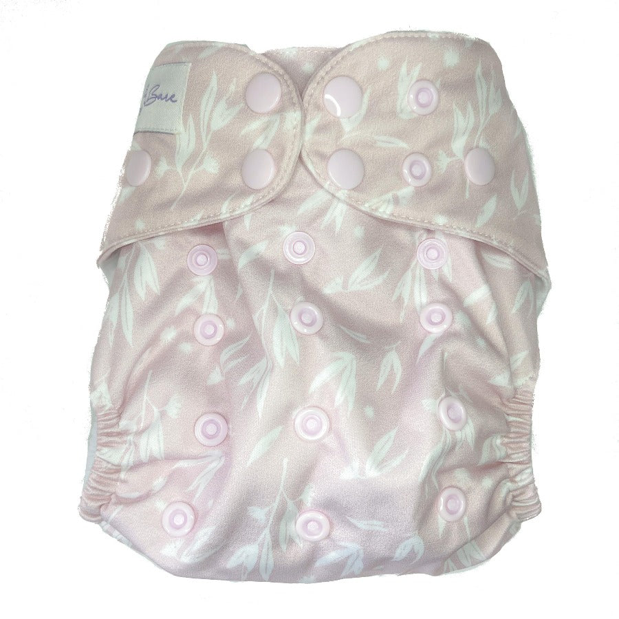 
                  
                    Pale pink cloth nappy with leaves on the fabric. 
                  
                
