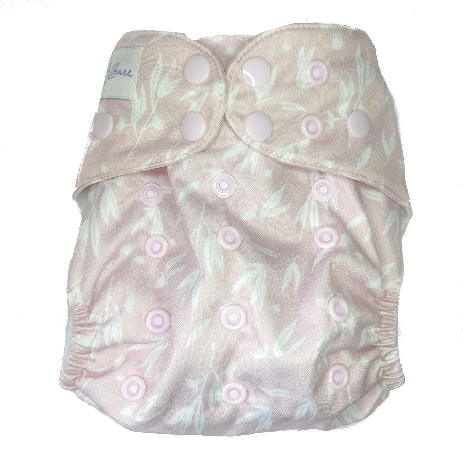 Load image into Gallery viewer, Pale pink cloth nappy with leaves on the fabric. 

