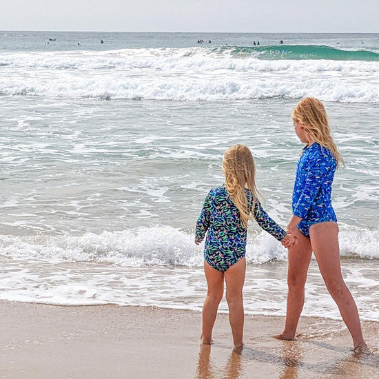 Load image into Gallery viewer, Two young girls holding hands at the beach
