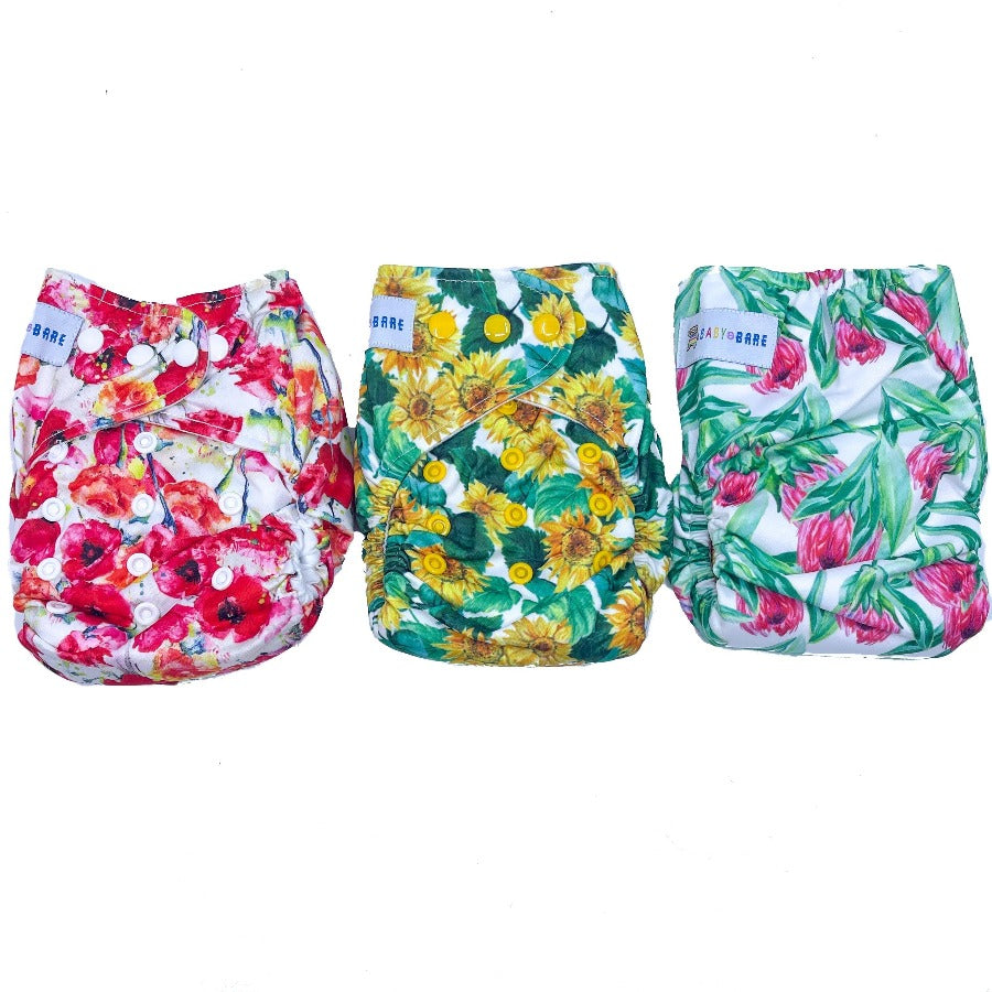 
                  
                    Three floral printed nappies photographed together
                  
                