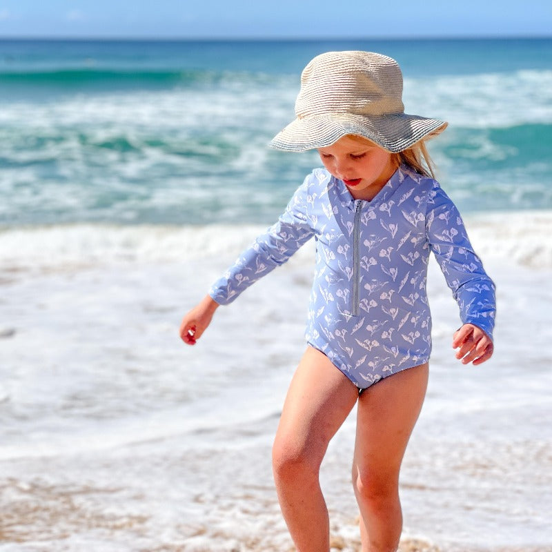 
                  
                    Little girl playing at beach
                  
                